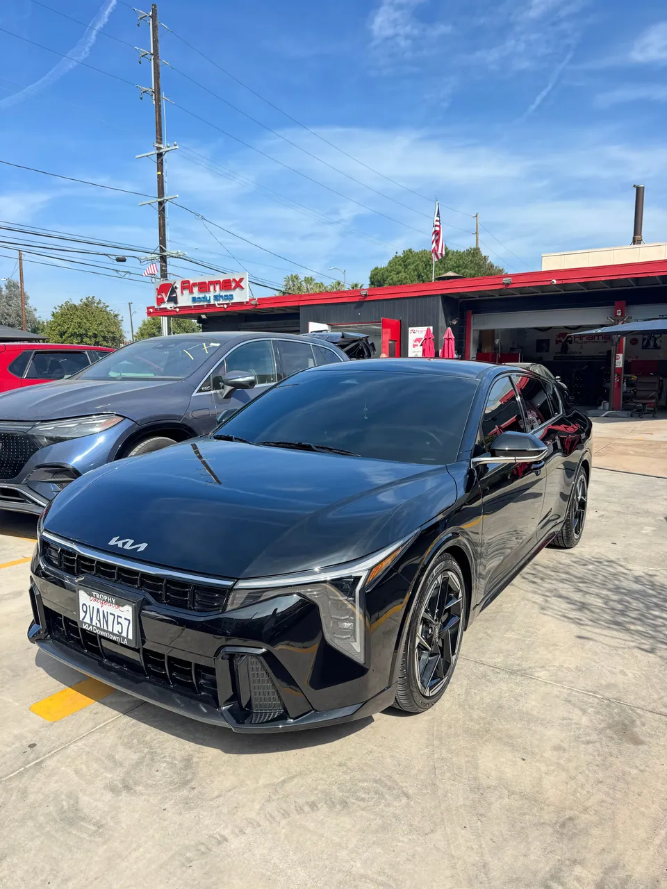 Black Kia EV6, front view, at Aramex Body Shop