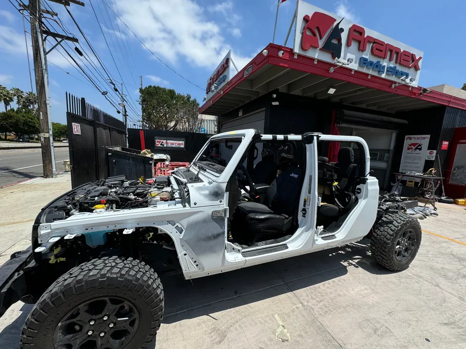 Jeep body stripped to the frame during repair at Aramex