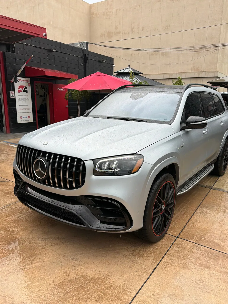 Silver Mercedes-Benz SUV parked beside the Aramex office