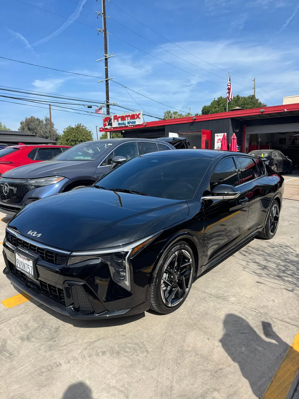 Black Kia EV6 in front of the Aramex garage