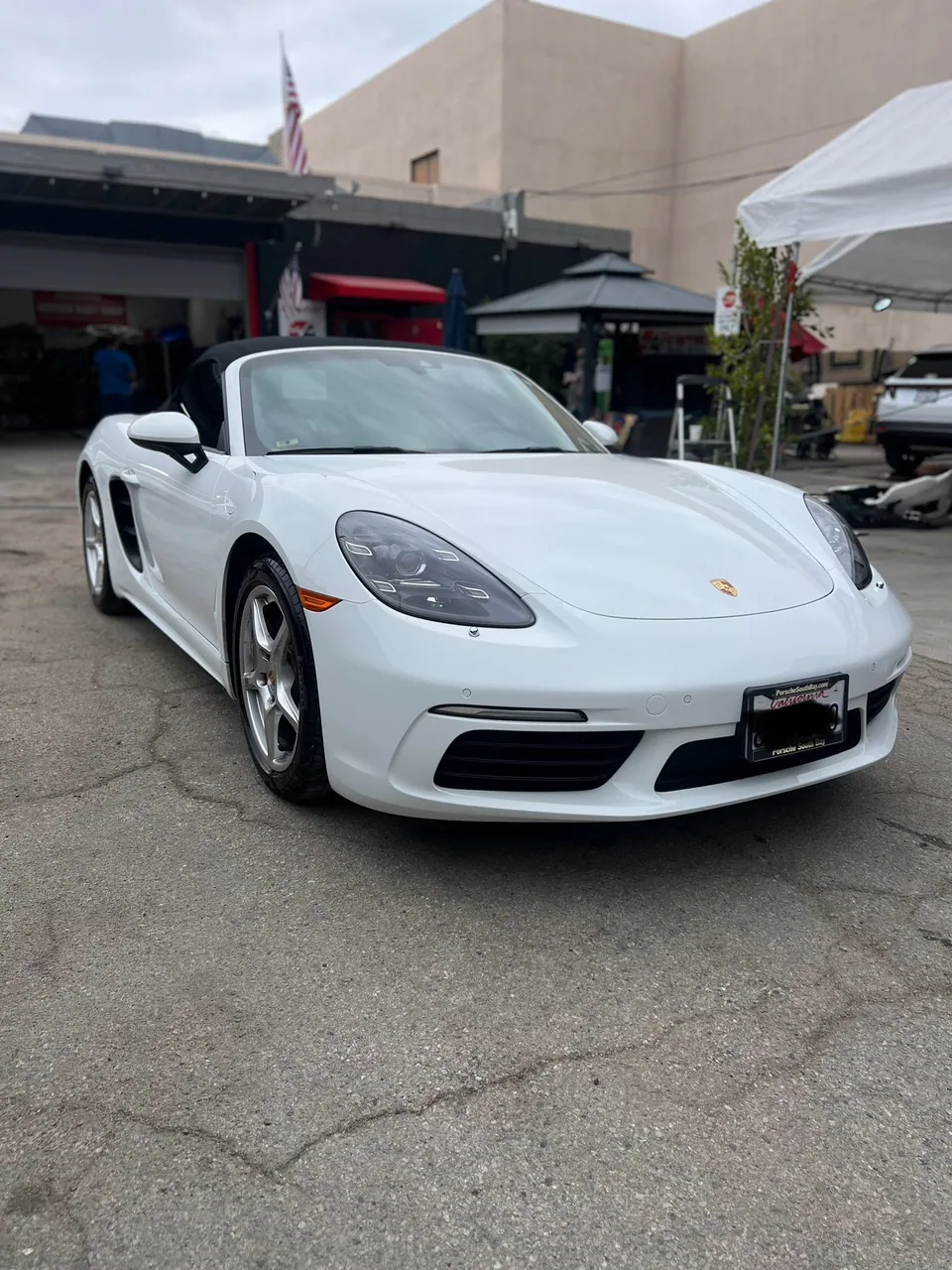 White Porsche sports car in the Aramex lot