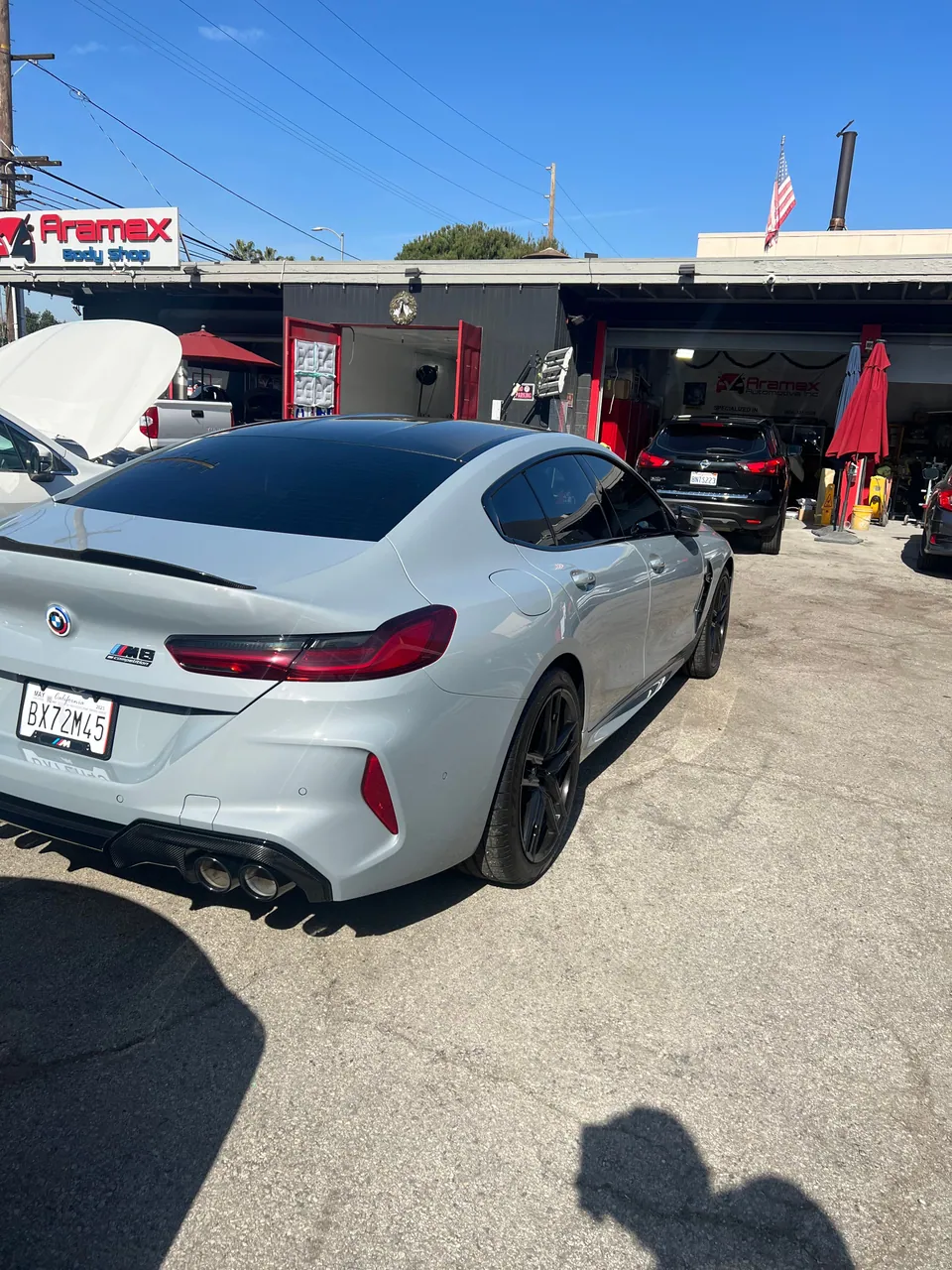 Gray BMW coupe parked outside the Aramex garage