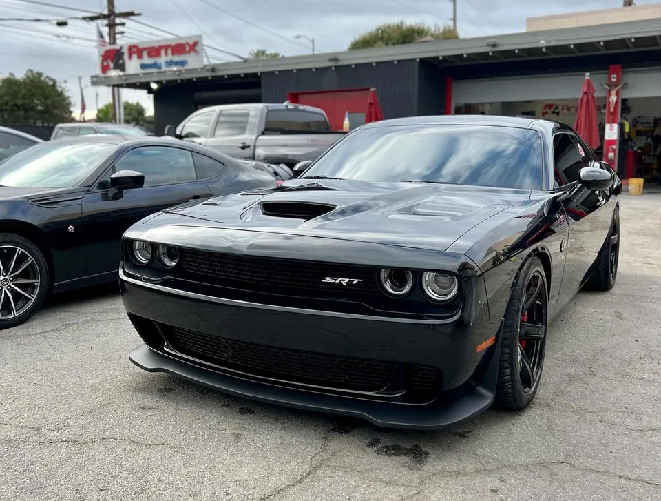 Black Dodge Challenger SRT in front of the Aramex garage