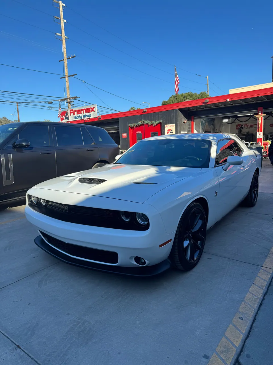White Dodge Challenger in the Aramex Body Shop lot